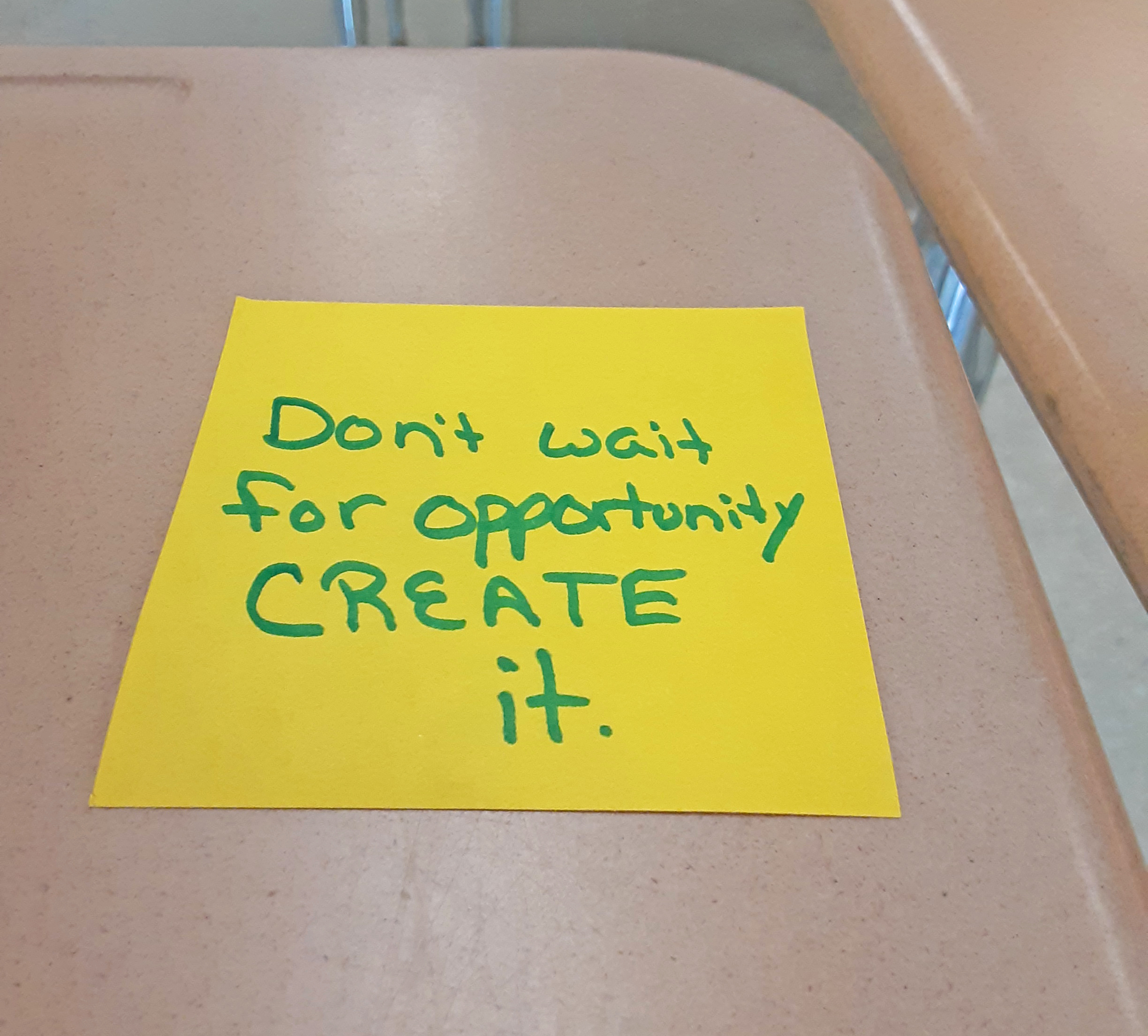 A post-it note left on a desk for a student.